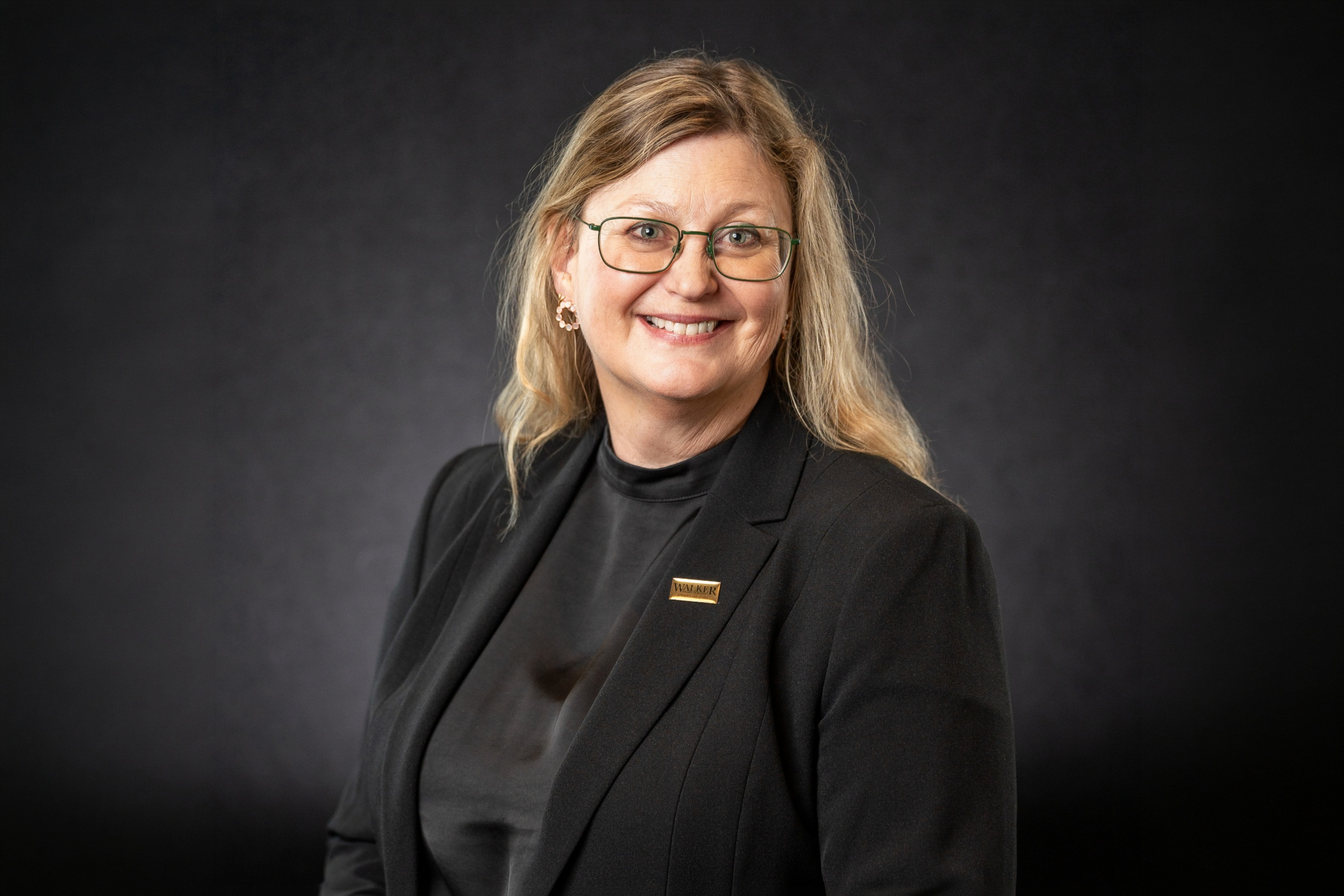 Headshot of Pia Albinsson, PhD, MBA, against a black background.