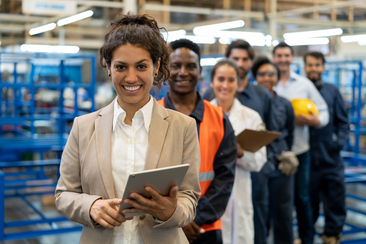 A Project Engineer Standing at the Head of a Line of Workers in a Warehouse.